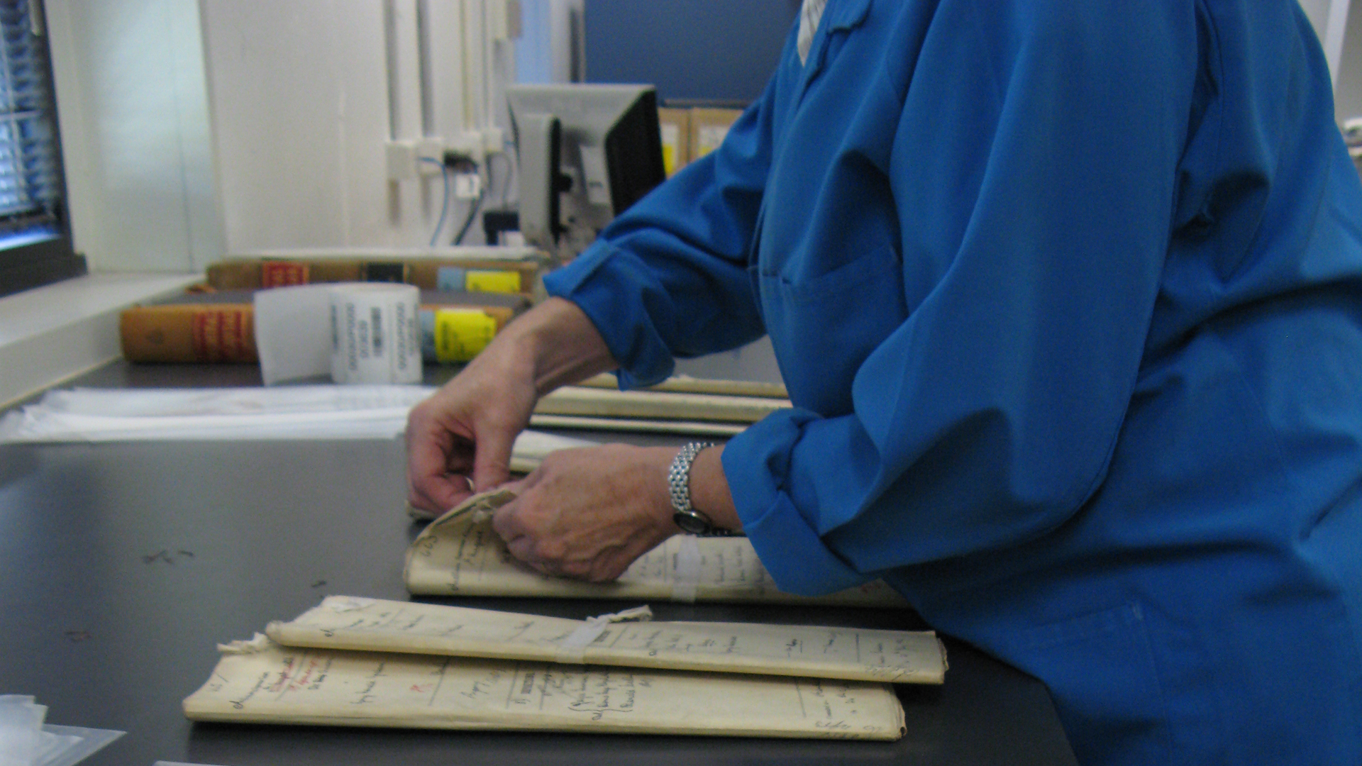 Image of archivist handling records 
